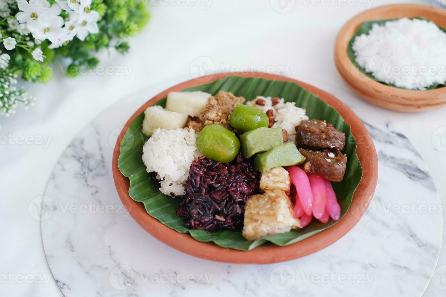 Jenang Madura is a typical Indonesian food that consists of black sticky rice, porridge marrow, jenang grendul and red pearls that were given palm sugar and coconut milk photo