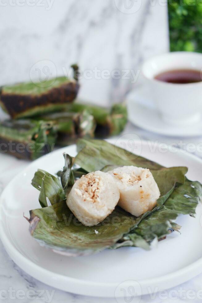 Lemper Bakar. Lemper is a traditional Indonesian snack made of glutinous rice and filled with chicken meat and wrapped in banana leaves. Selective focus photo
