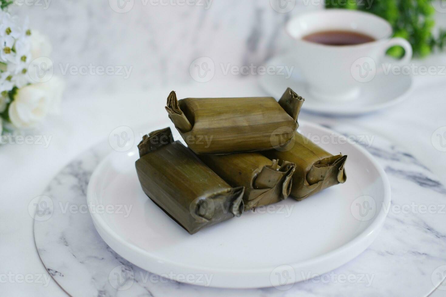 Arem-arem, a traditional food made from rice filled with vegetables, chicken, meat or tempeh wrapped in banana leaves. Arem-arem is popular as a breakfast substitute photo