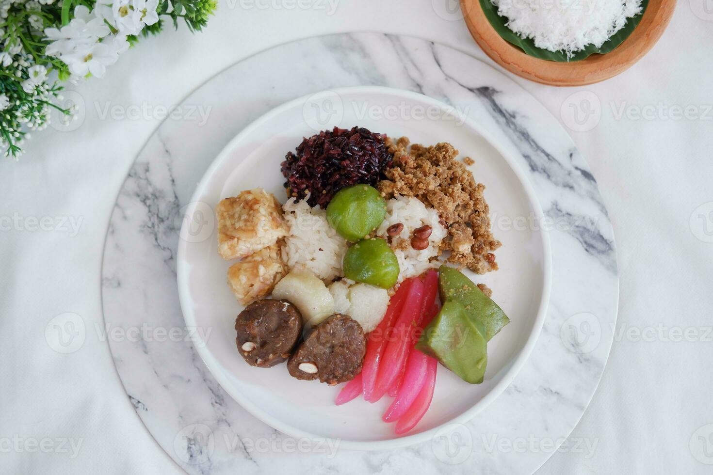 Jenang Madura is a typical Indonesian food that consists of black sticky rice, porridge marrow, jenang grendul and red pearls that were given palm sugar and coconut milk photo
