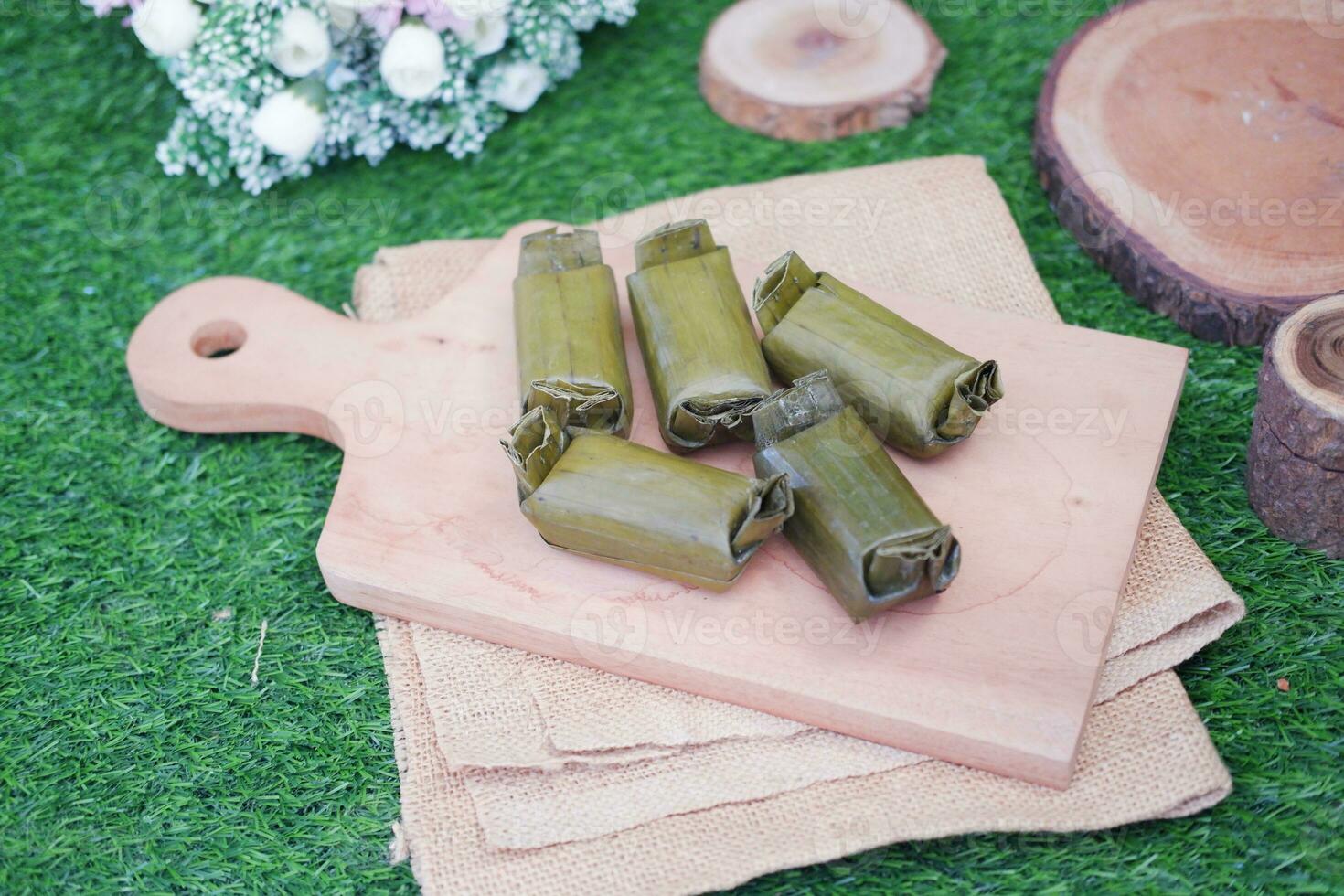 Arem-arem, a traditional food made from rice filled with vegetables, chicken, meat or tempeh wrapped in banana leaves. Arem-arem is popular as a breakfast substitute photo