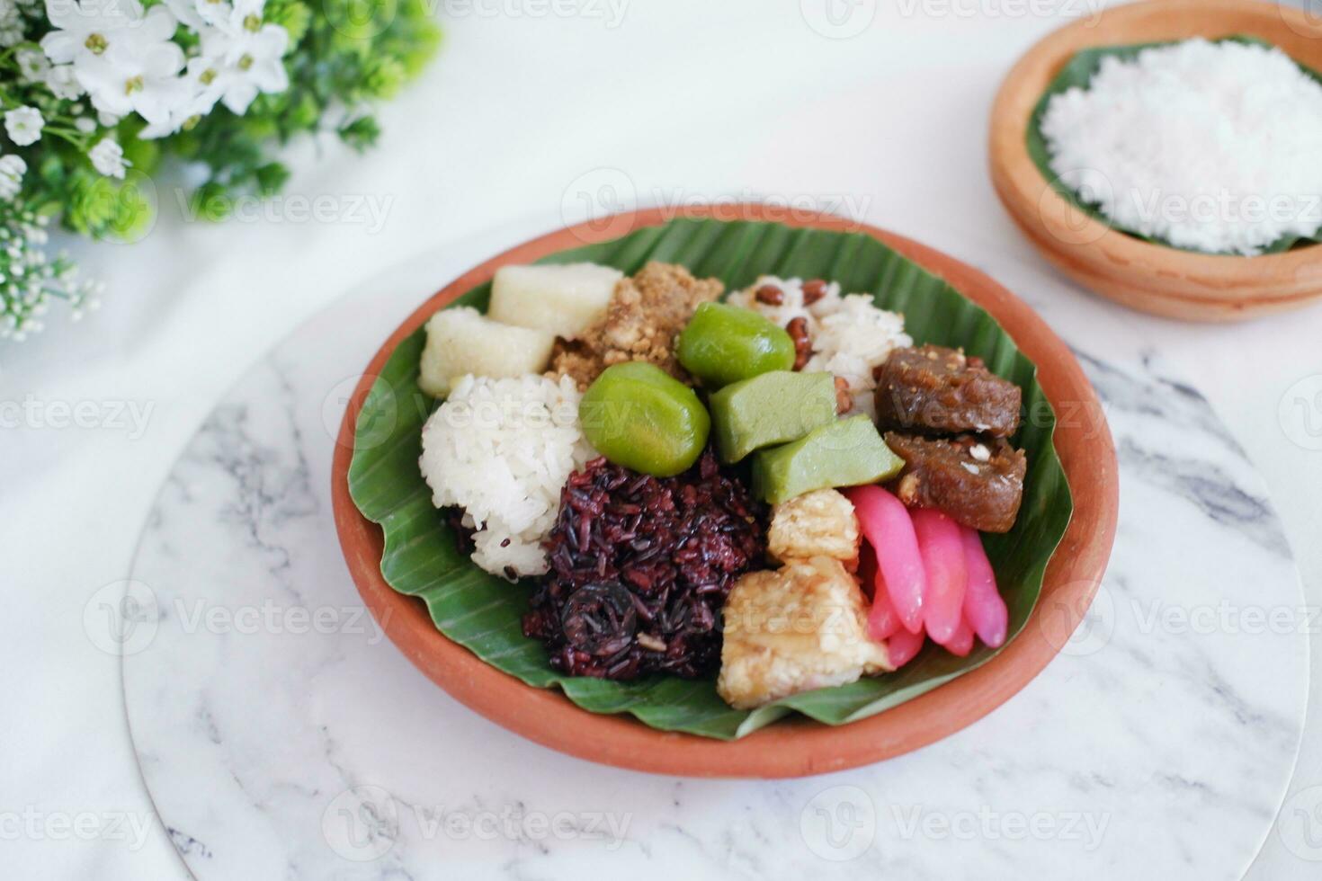Jenang Madura is a typical Indonesian food that consists of black sticky rice, porridge marrow, jenang grendul and red pearls that were given palm sugar and coconut milk photo