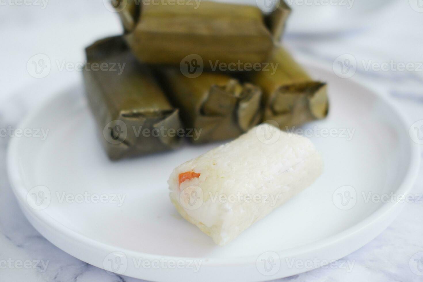 Arem-arem, a traditional food made from rice filled with vegetables, chicken, meat or tempeh wrapped in banana leaves. Arem-arem is popular as a breakfast substitute photo