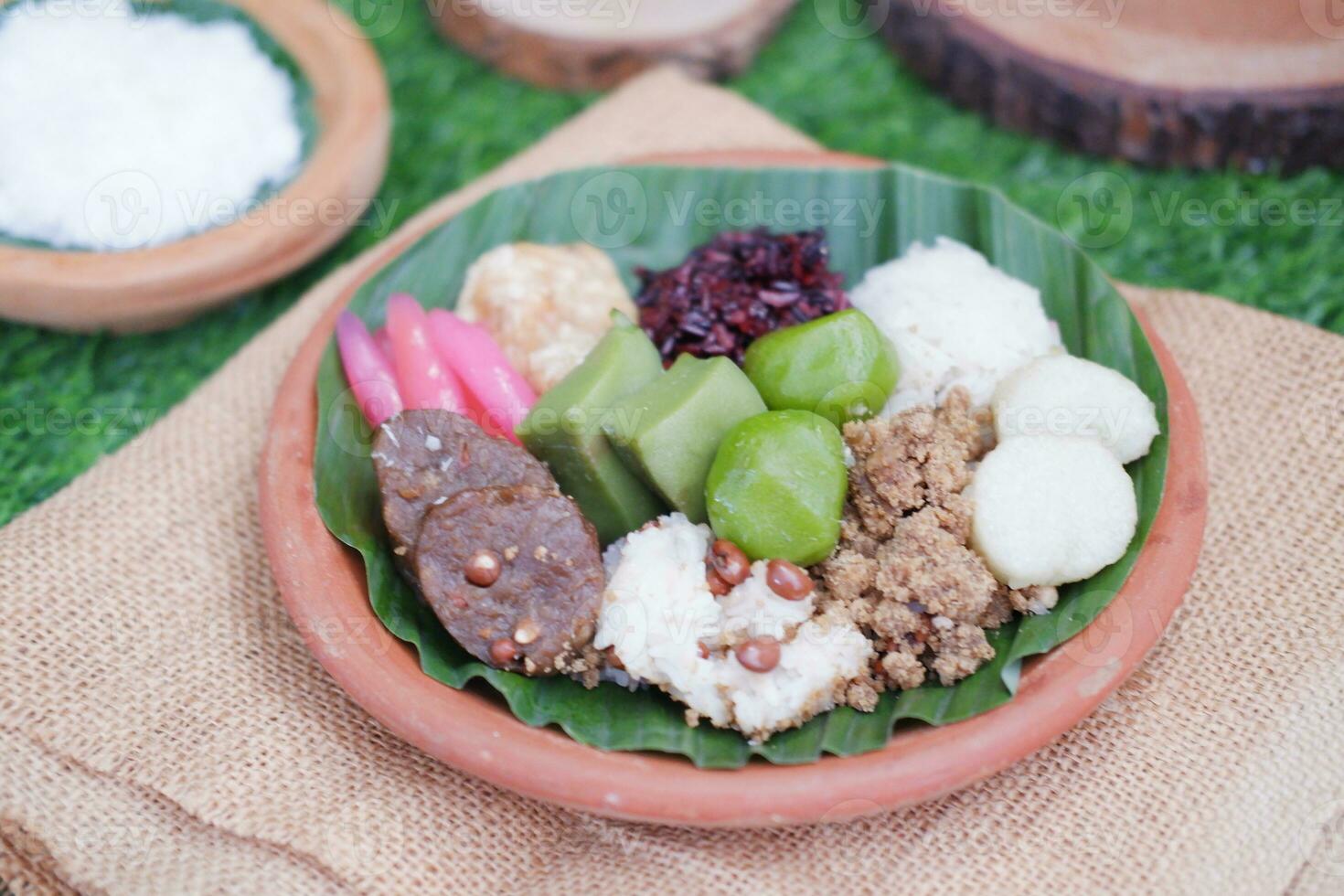 Jenang Madura is a typical Indonesian food that consists of black sticky rice, porridge marrow, jenang grendul and red pearls that were given palm sugar and coconut milk photo