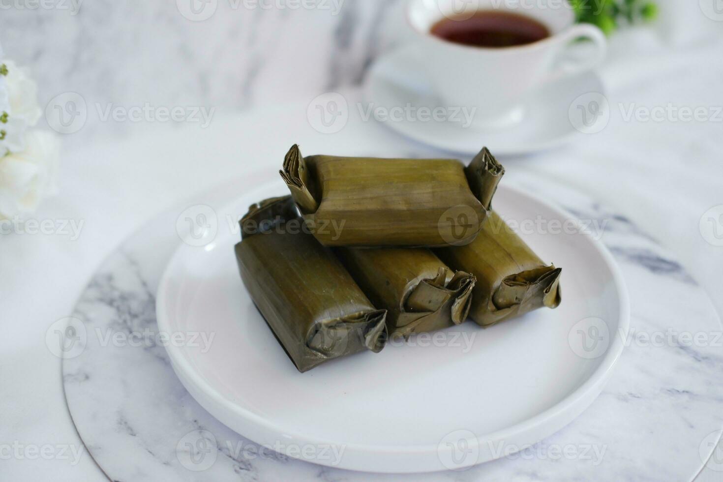 Arem-arem, a traditional food made from rice filled with vegetables, chicken, meat or tempeh wrapped in banana leaves. Arem-arem is popular as a breakfast substitute photo