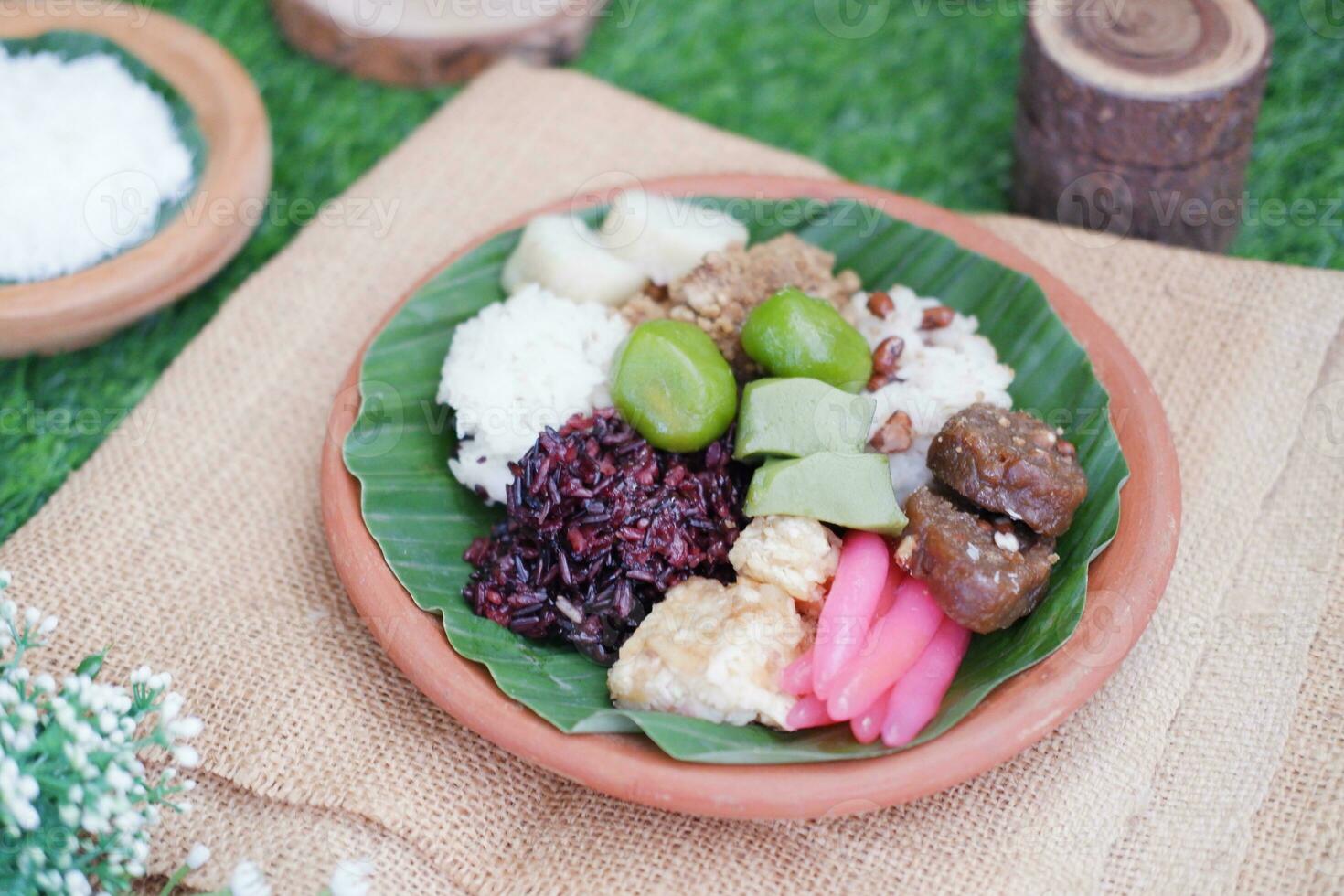 Jenang Madura is a typical Indonesian food that consists of black sticky rice, porridge marrow, jenang grendul and red pearls that were given palm sugar and coconut milk photo