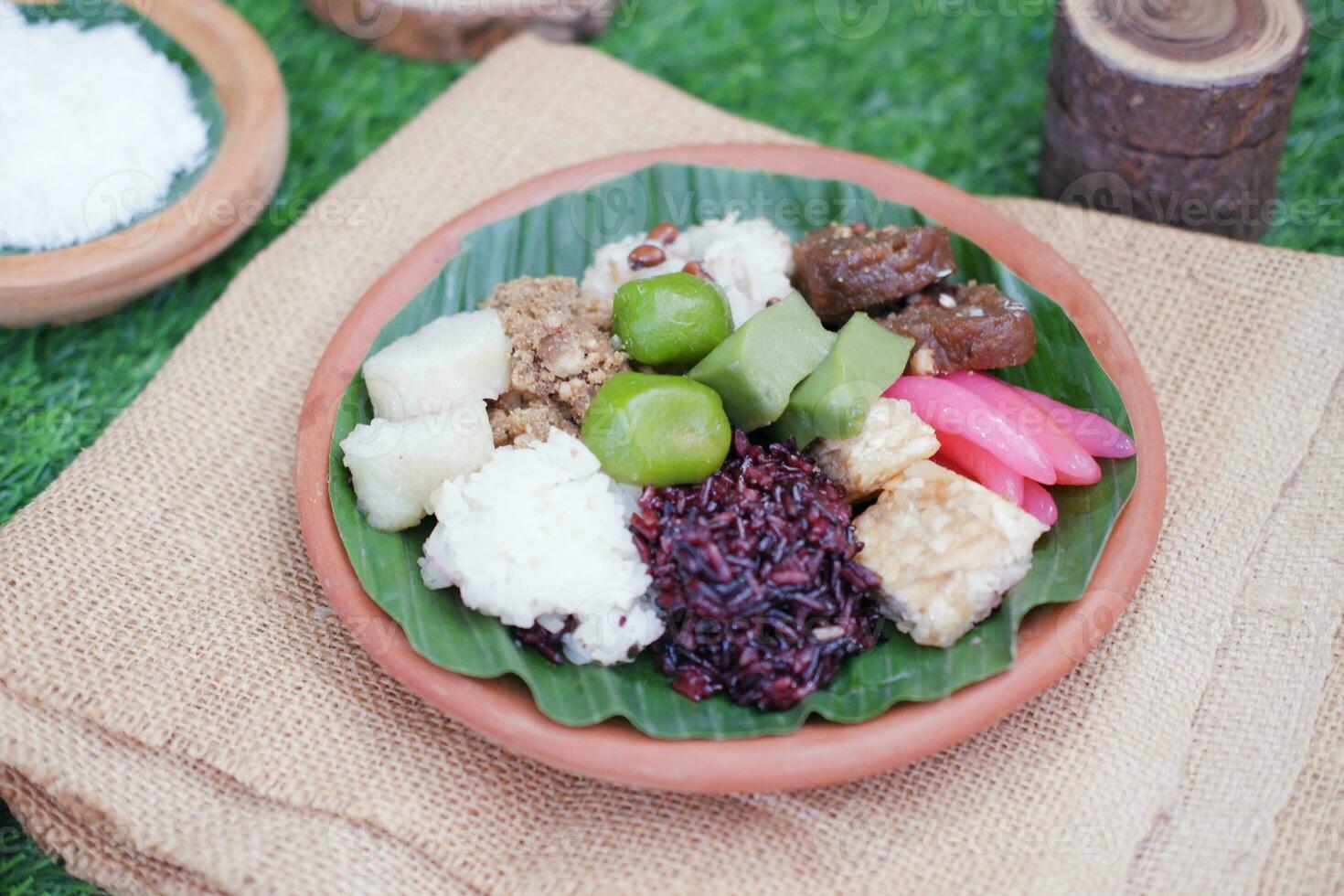 Jenang Madura is a typical Indonesian food that consists of black sticky rice, porridge marrow, jenang grendul and red pearls that were given palm sugar and coconut milk photo