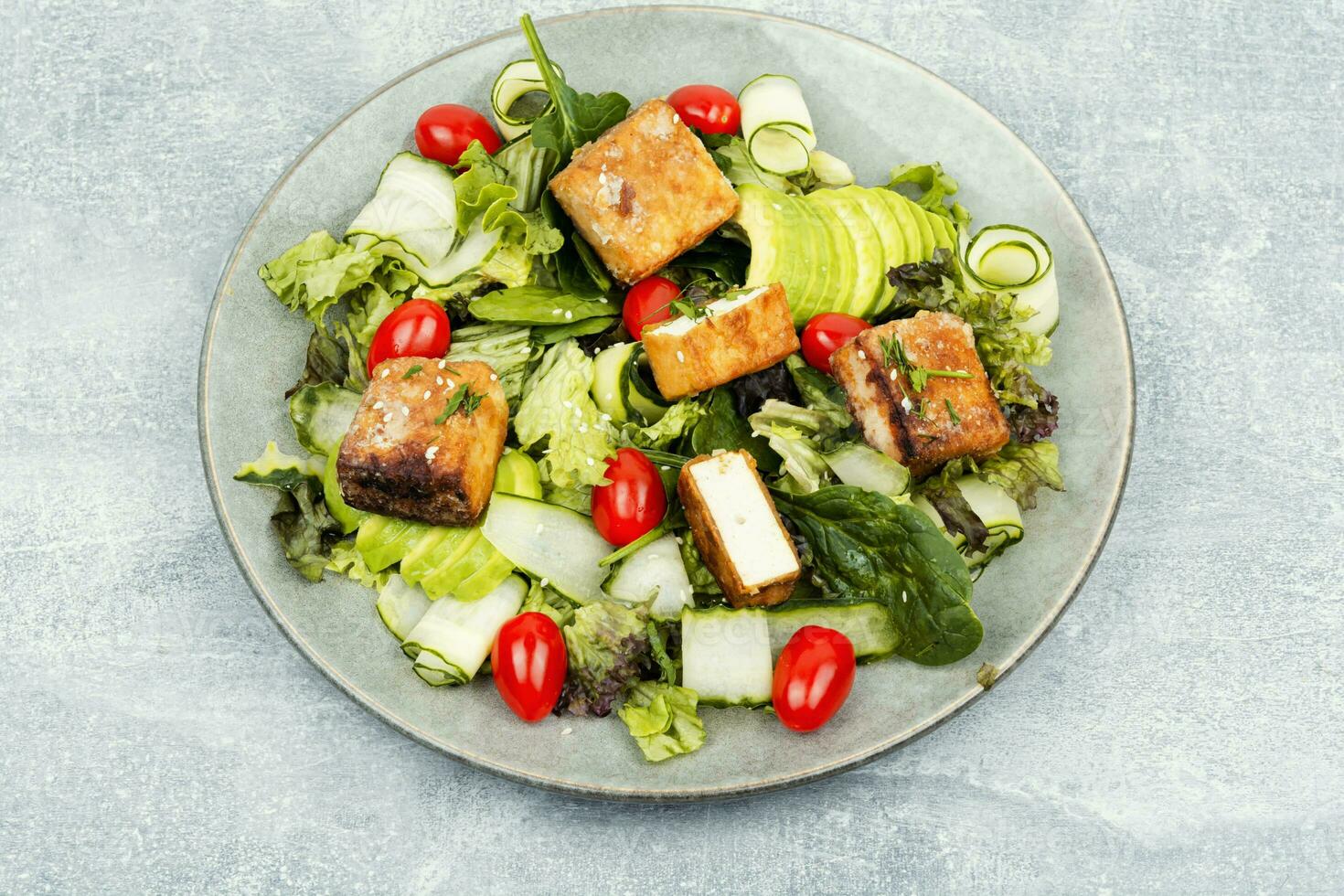 Salad with fresh vegetables and tofu. photo