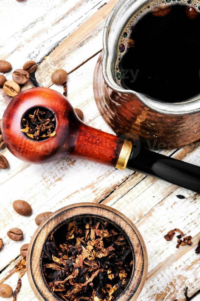 Smoking pipe and coffee photo