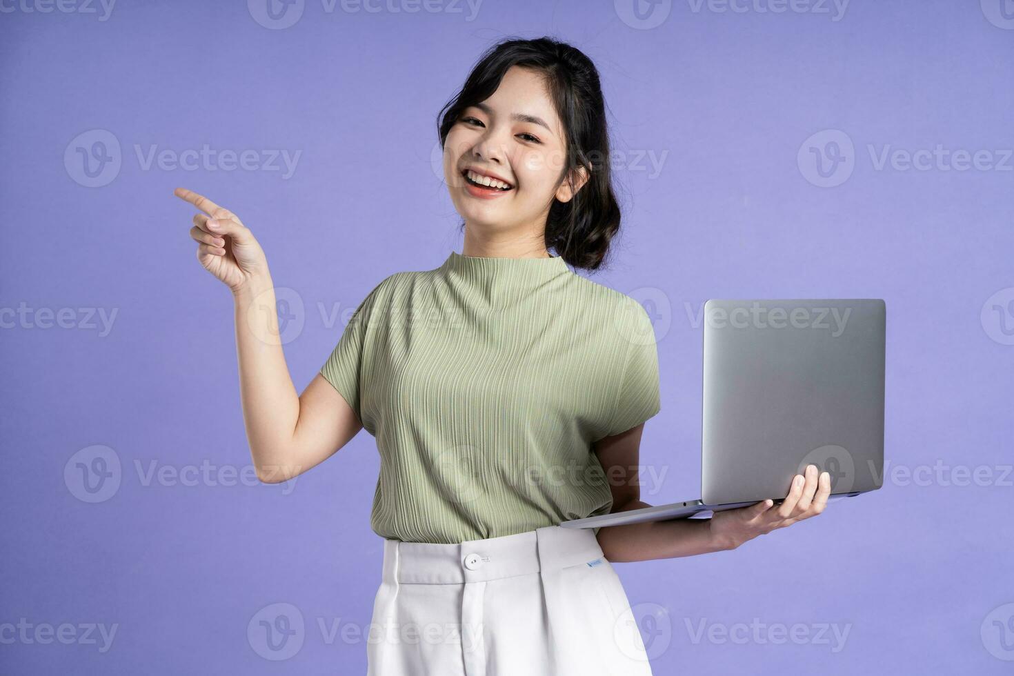 Portrait of beautiful asian woman posing on purple background photo