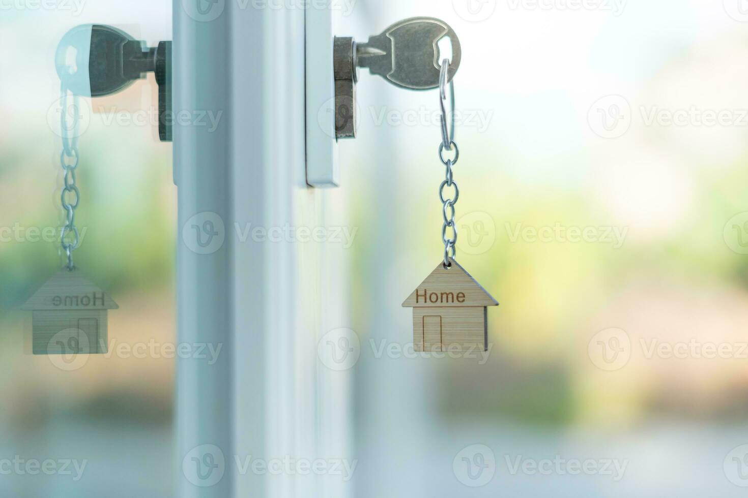 Landlord key for unlocking house is plugged into the door. Second hand house for rent and sale. keychain is blowing in the wind. mortgage for new home, buy, sell, renovate, investment, owner, estate photo