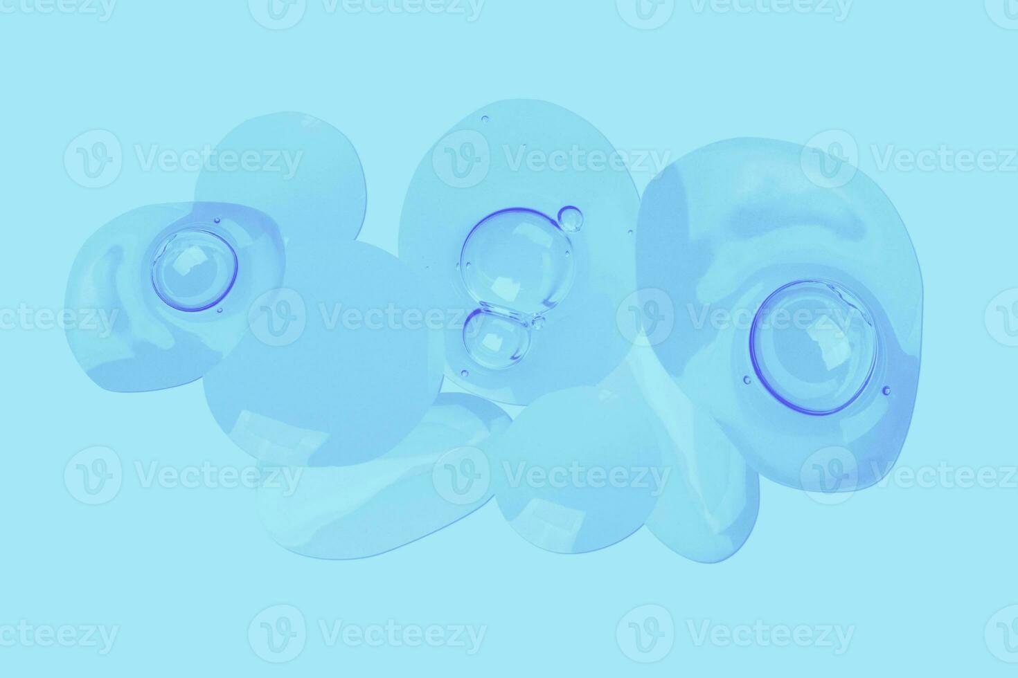 drops of transparent gel with air bubbles on a blue background photo