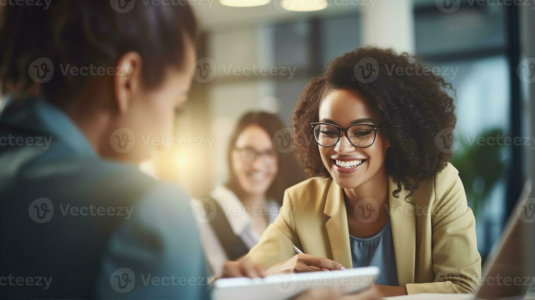 A joyful woman with curly hair and glasses sharing a moment with her colleague in a well-lit modern office environment. Generative AI photo