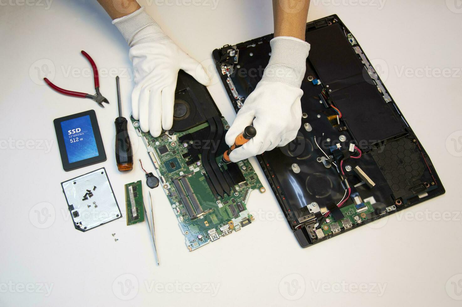 Top view. Technician repairing notebook computer, repairing motherboard and circuit. photo