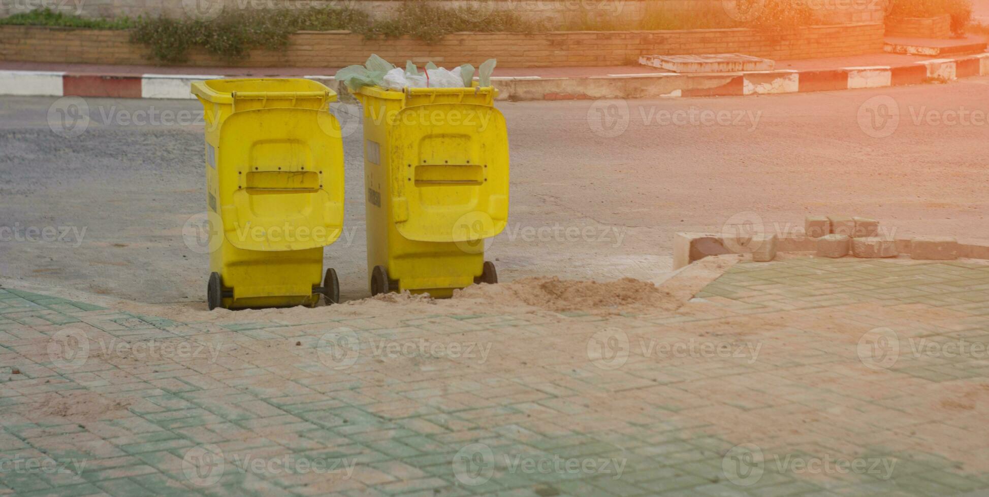 Yellow trash can in the park photo