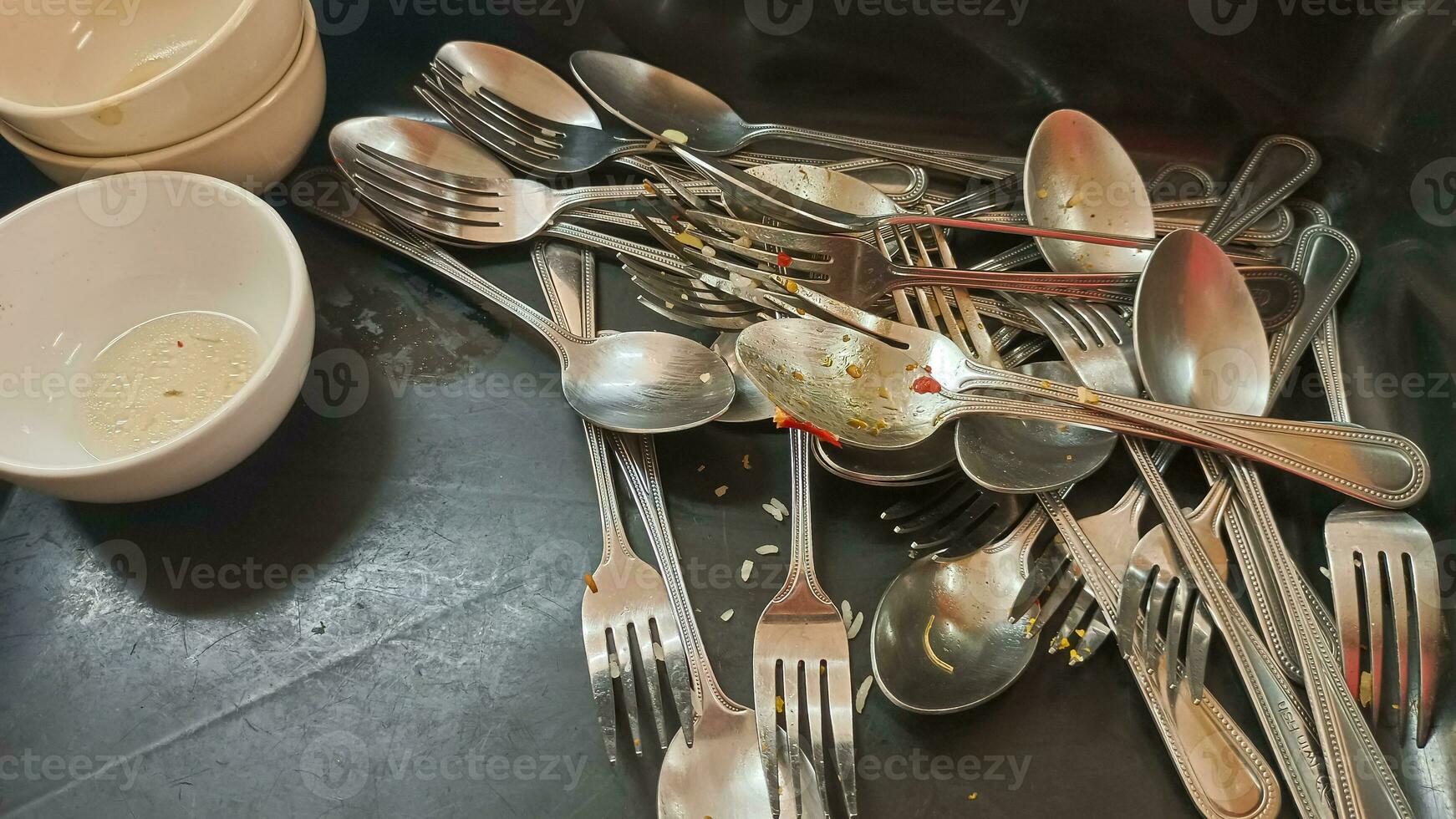 Unwashed spoons and fork after meals photo