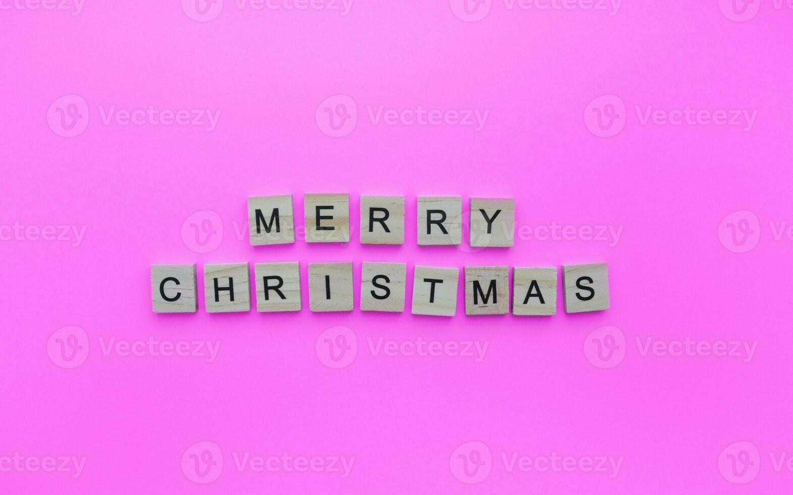 December 25, Christmas, minimalistic banner with the inscription in wooden letters on a pink background photo