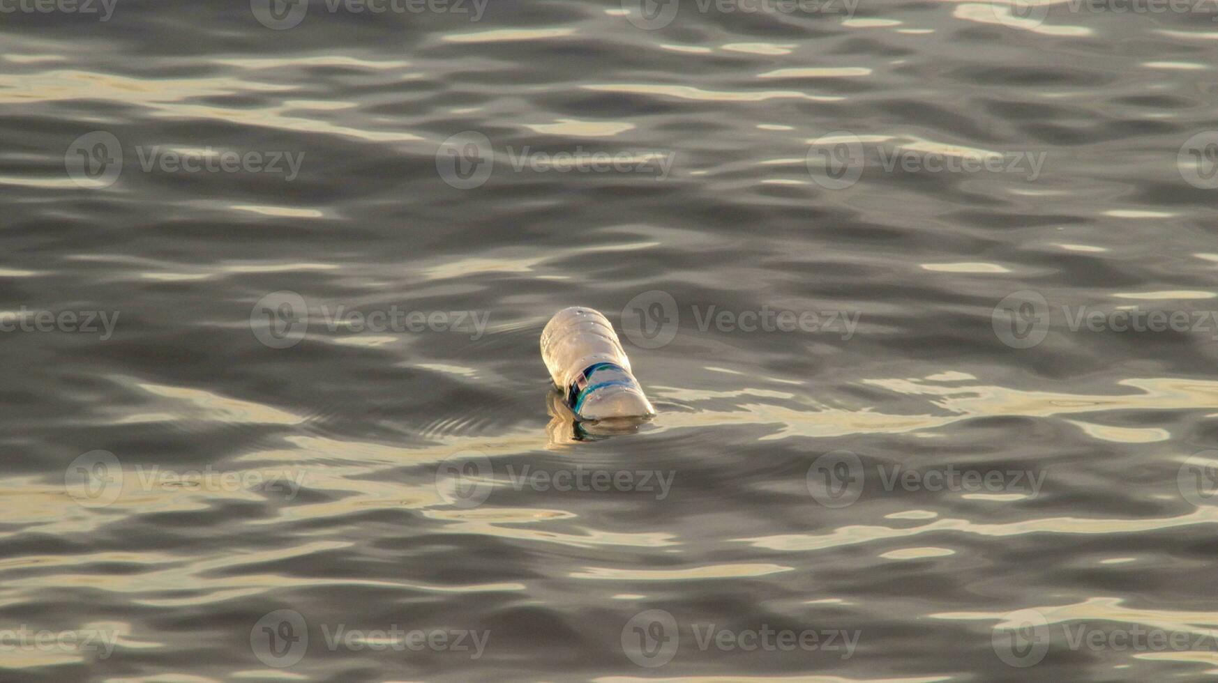 Plastic bottles of mineral water floating in the ocean. Plastic waste environmental pollution. photo