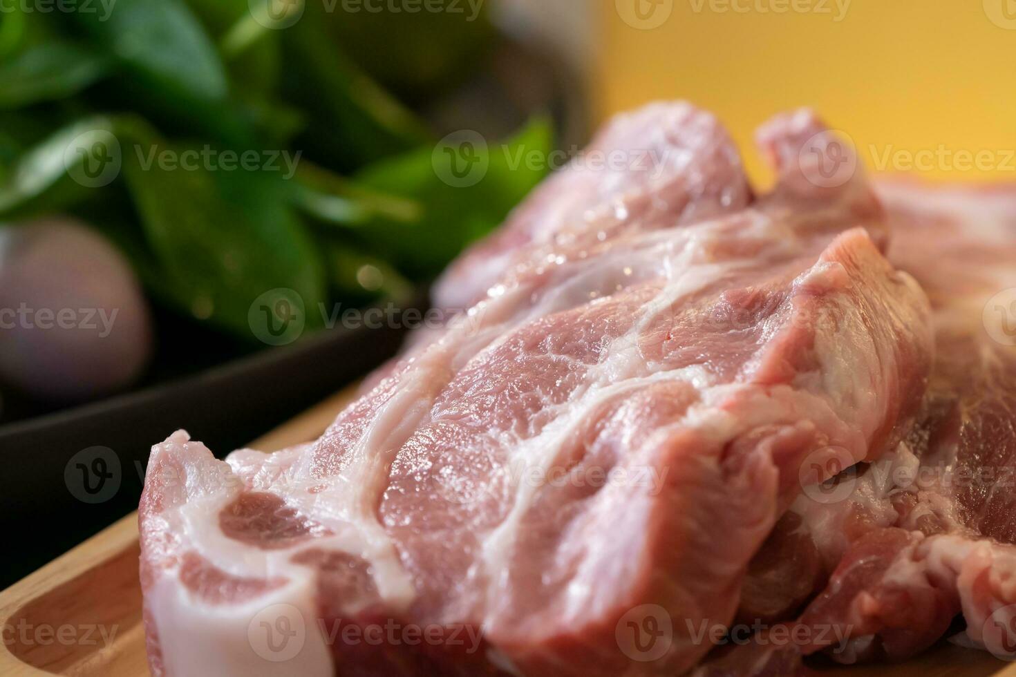 Close up macro shooting sliced pork meat on wood plate in studio light. photo