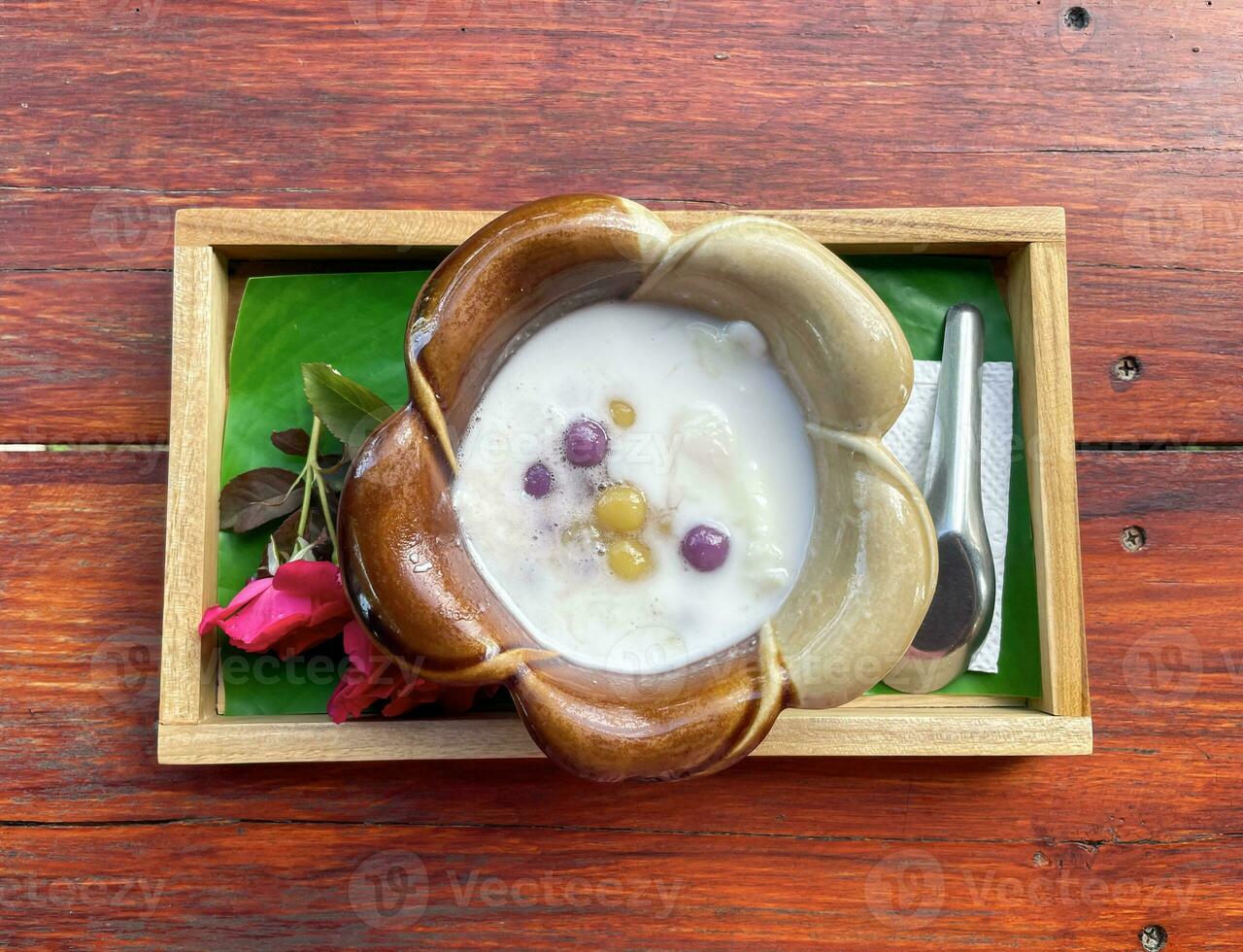 Bua Loi is a Thai dessert made from glutinous rice flour molded into small, round pellets of various colors. Its sweet taste can add young coconut meat. Ice cream and sweet eggs photo