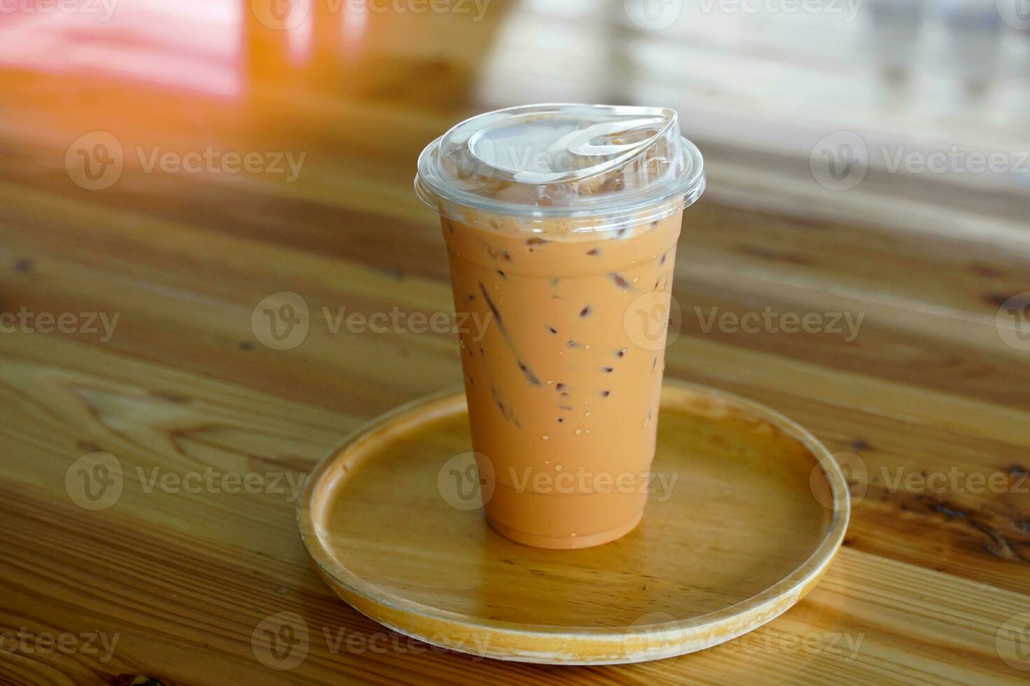 Teh Tarik,pulled tea is a milk tea drink made from concentrated black tea mixed with evaporated milk. Brewing requires skill and skill in pouring tea from one container to another until it bubbles. photo