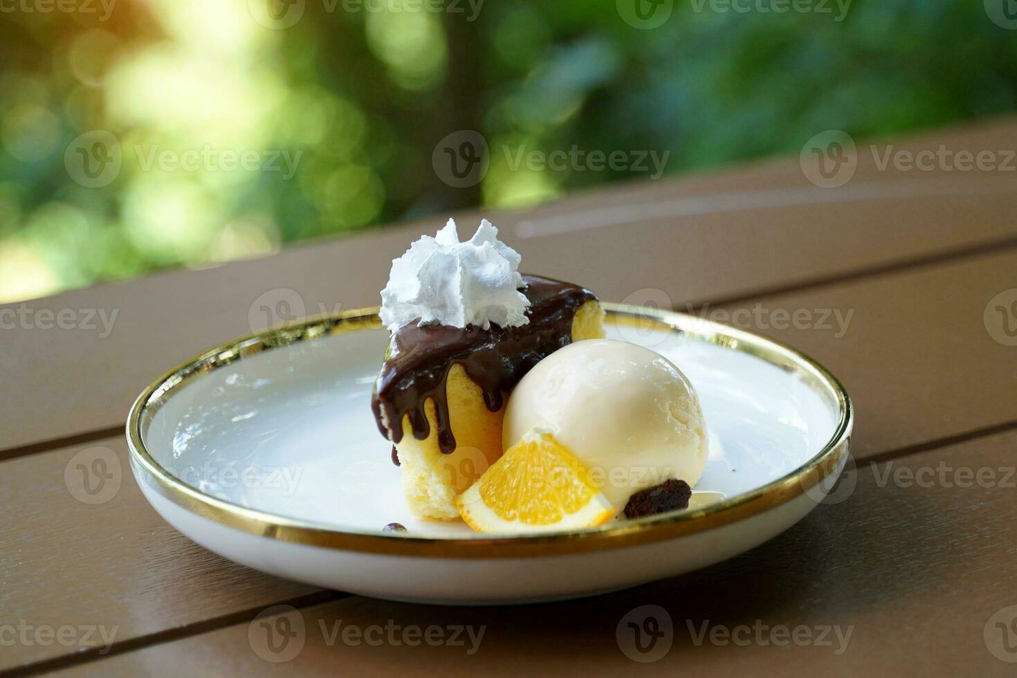 Cocoa Cotton Cake is a cake with a strong cream cheese flavor. The texture is soft and light, similar to chiffon. Gently top the cake with cocoa, serve with ice cream and decorate with orange petals. photo