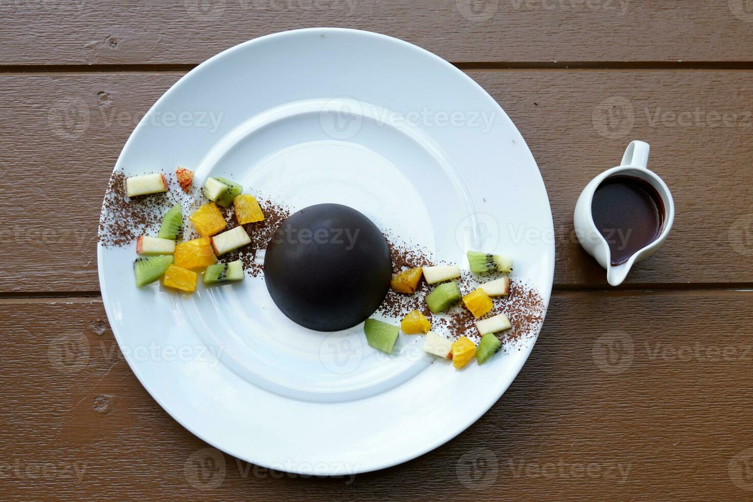 Chocolate dome by covering cookies. Fruit and ice cream of your choice. How to eat, Put warm chocolate on the dome until it melts and you're ready to enjoy the rich ice cream and chocolate lattice. photo