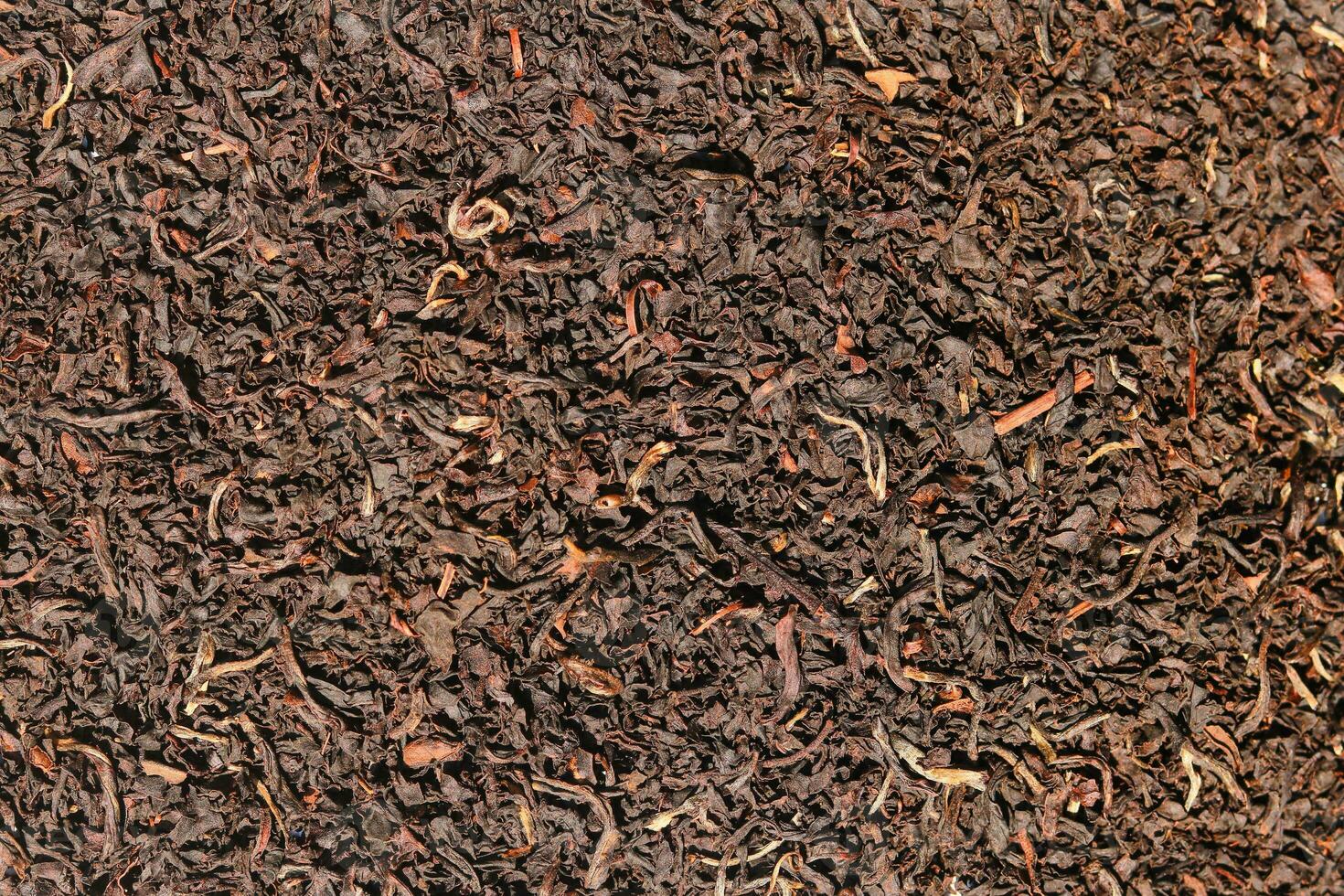 Background of tea, Dry black tea leaves closeup as background, Top view closeup photo