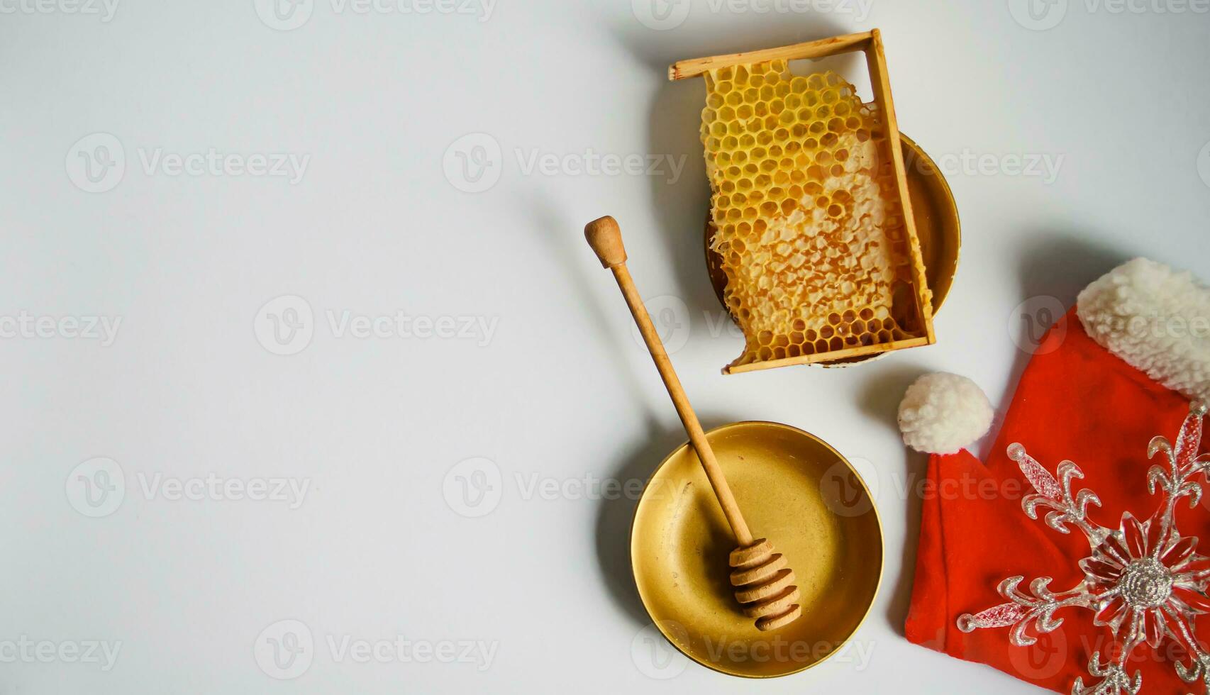 broken yellow honeycomb with honey near alarm clock on table. Honey products. healthy natural food concept. christmas and new year background for beekeeping photo