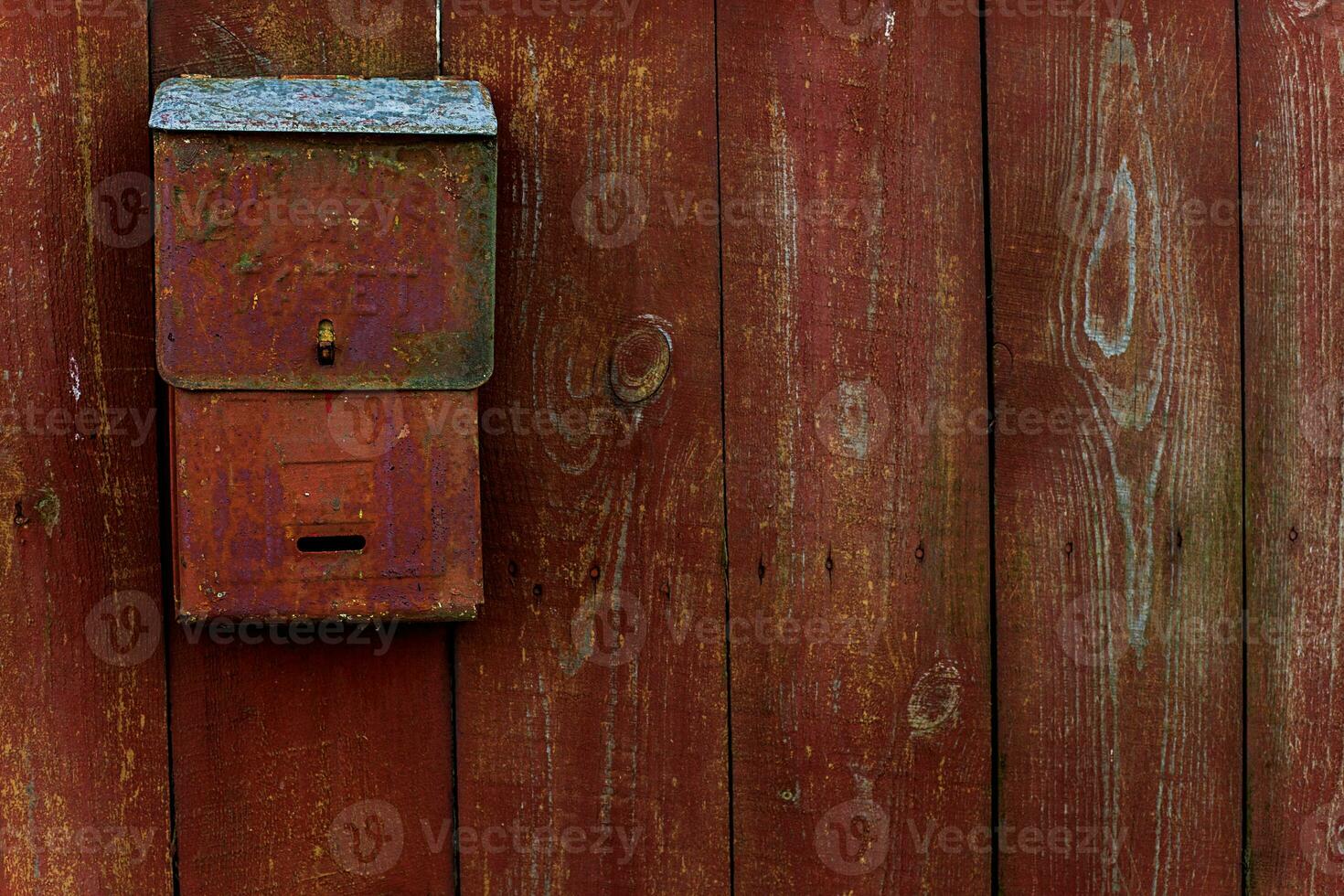 For letters and newspapers. Translation of the Russian text. Mail box on the wooden fence red photo