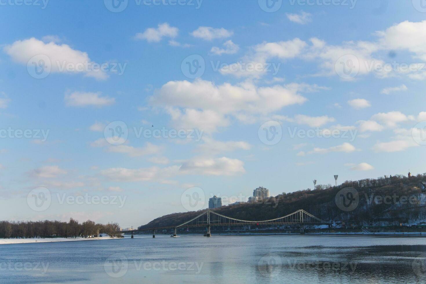 Freezing river Dnieper in Kiev. View of the Pechersk Hills in winter. The slopes of the hills of the city are covered with snow. photo