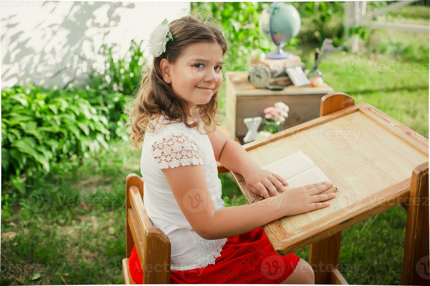 schoolgirl listening to teacher during the lesson in primary school. Learning outside the auditorium during coronavirus quarantine. Back to school concept photo