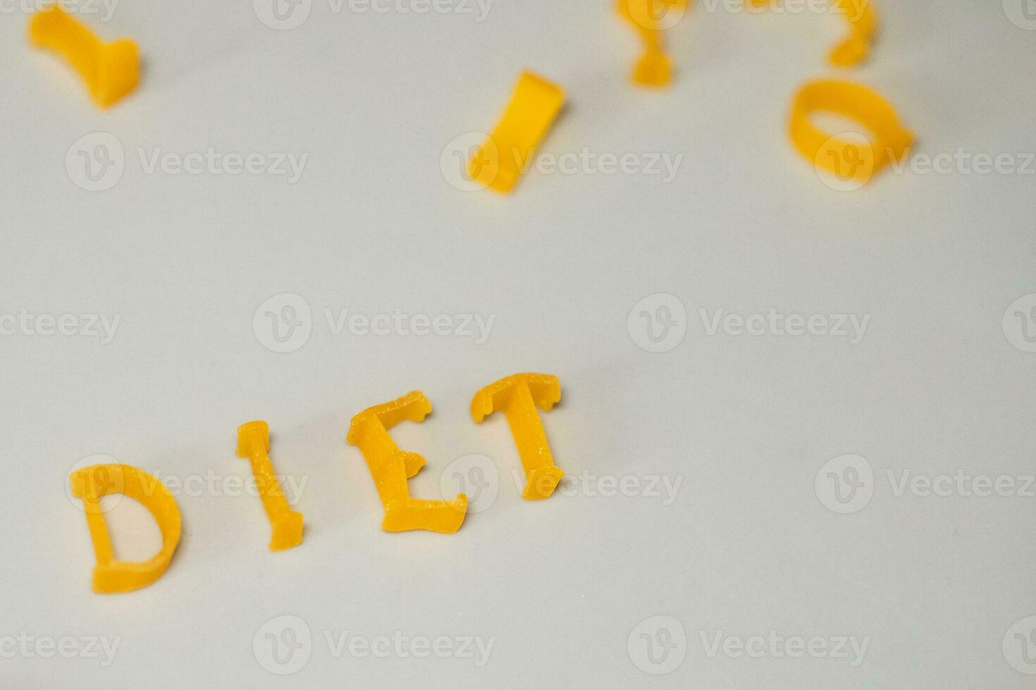 word DIET consists of edible letters. Pasta Diet Food. Pasta in form of letters on gray background. Proper nutrition concept. photo