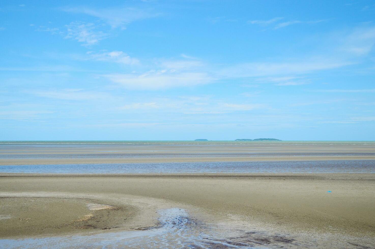 Low tide at sea with blue sky photo