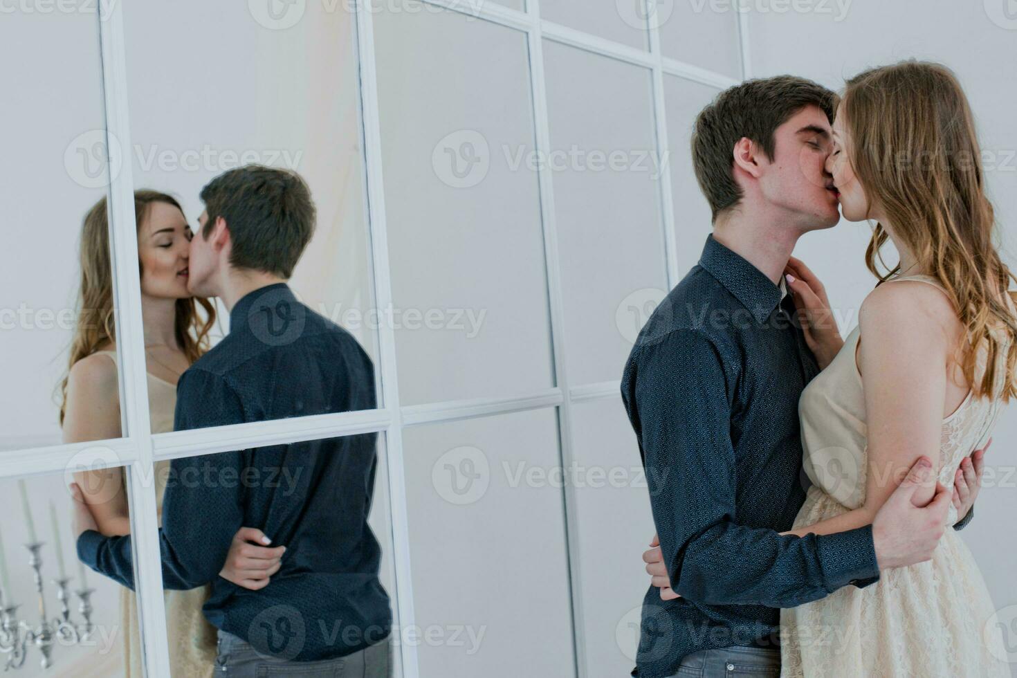 sex couple kisses. Lovers embrace. boy kisses girl on lips. Reflection of lovers in mirror. Happy couple in love. Valentine's Day. photo