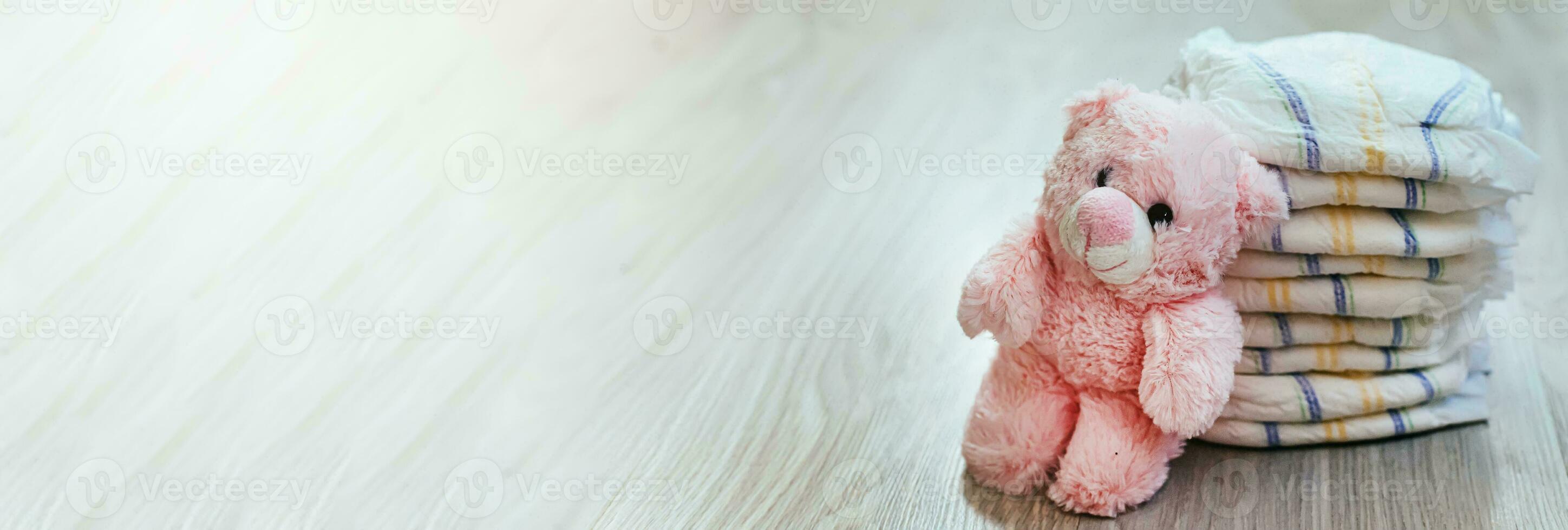 Diapers with a pink teddy bear. Hygiene of newborns. photo