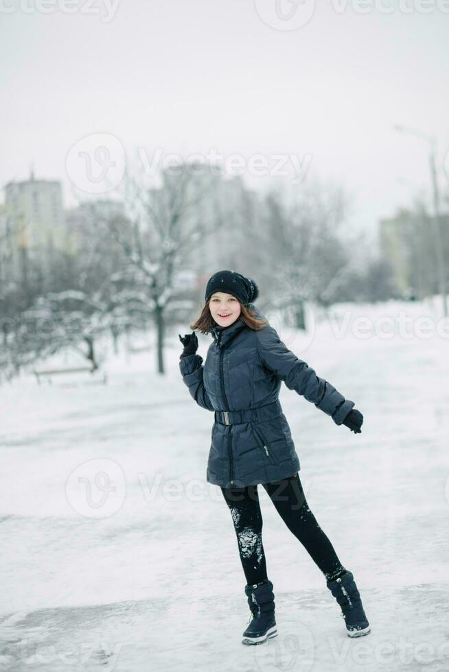 Teen girl froze. The child warms, hands clasped to his face. Portrait of a beautiful girl. photo