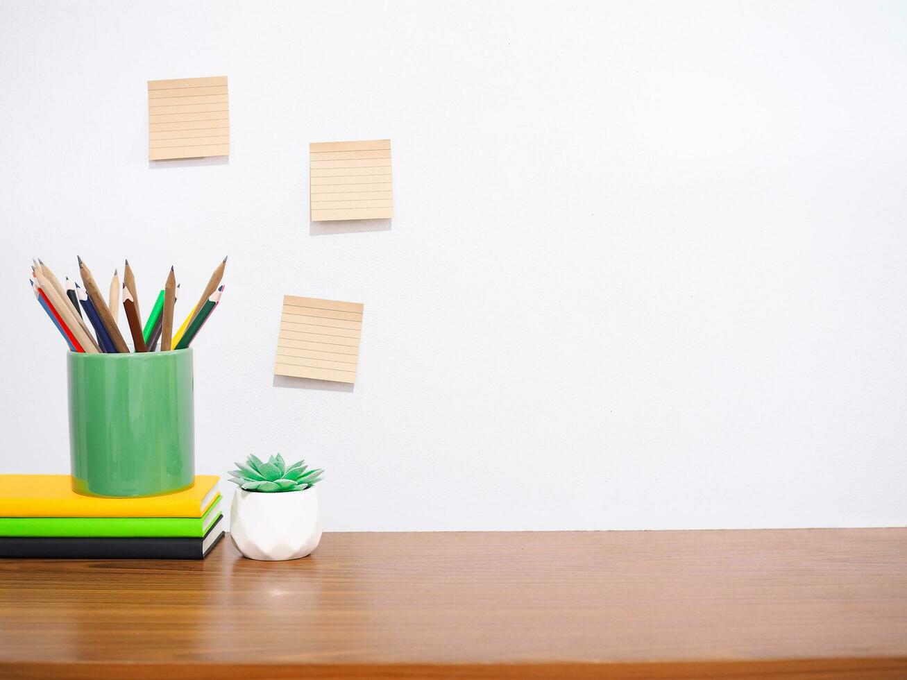 Office desk table, Student creative desktop with colorful stationery, hardcover book, potted cactus, sticky notes. Copy space for text, Back to school, Education concept photo