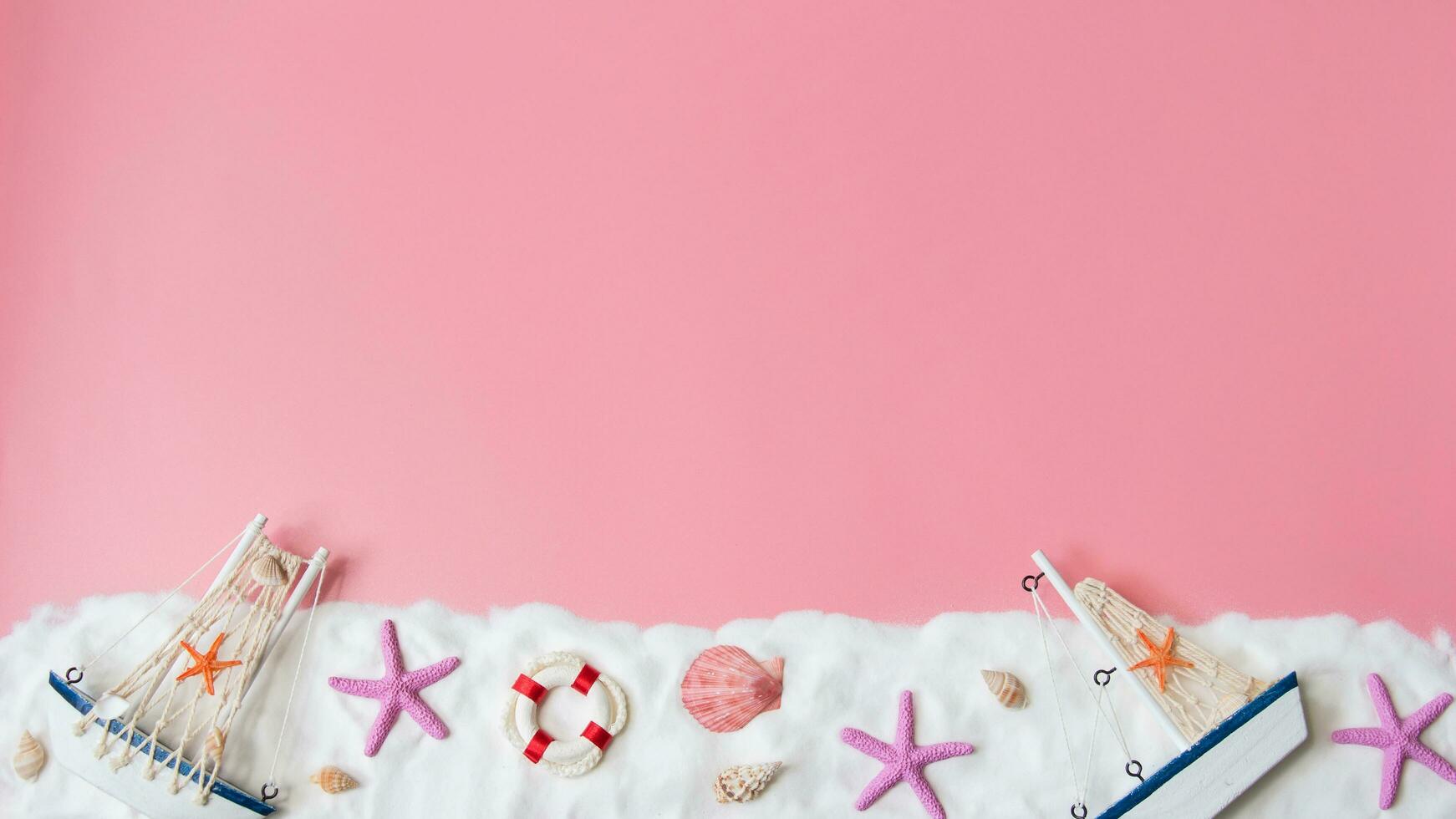 Top view of summer beach decoration on pink background, copy space for text photo