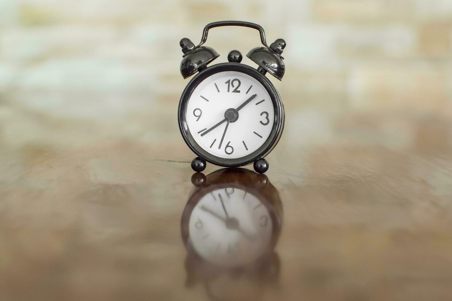 Black alarm clock with bells on the table photo