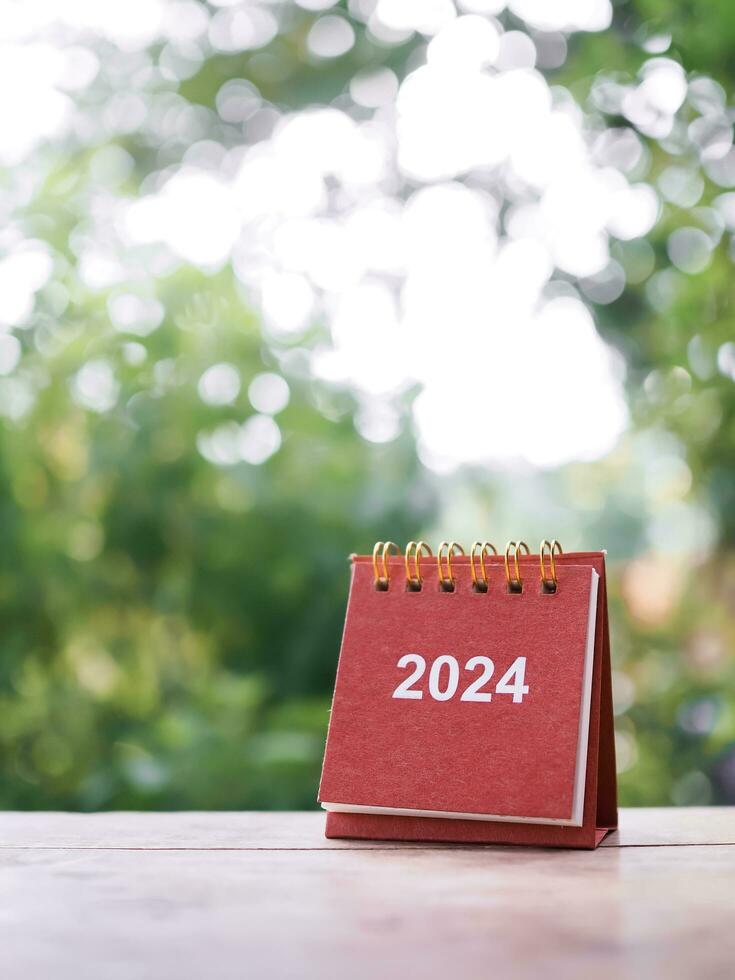 Close up 2024 desk calendar on the table with copy space. Resolution, Goal, Action, Planning, and manage to success business. photo