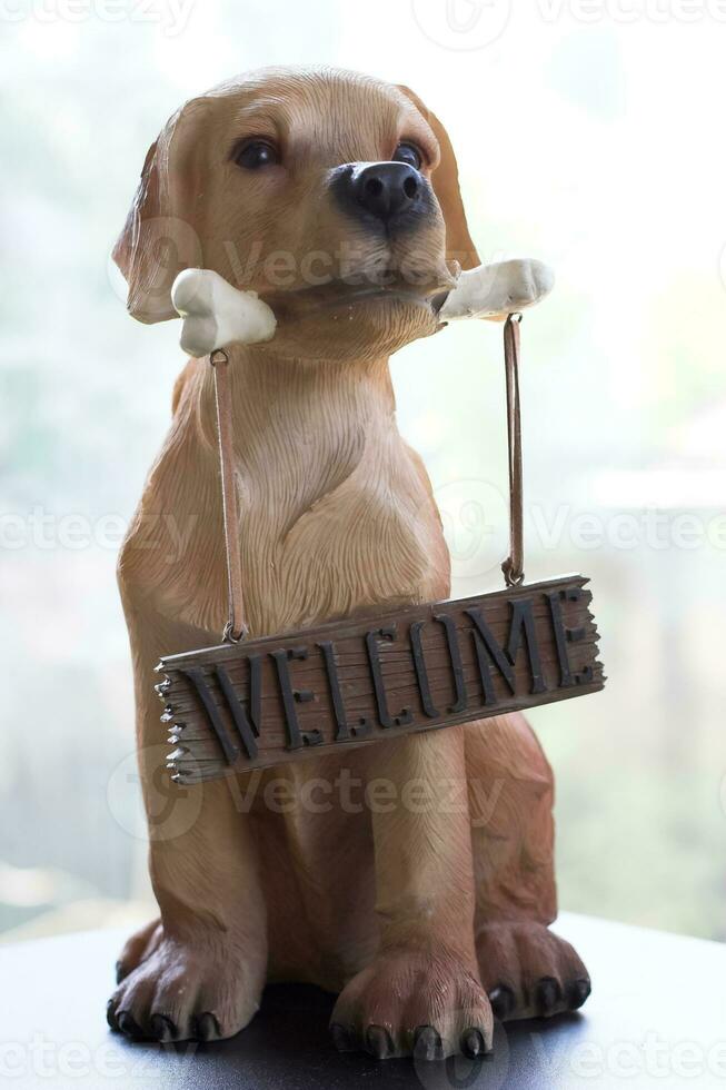 Dog holding a bone on which hangs photo