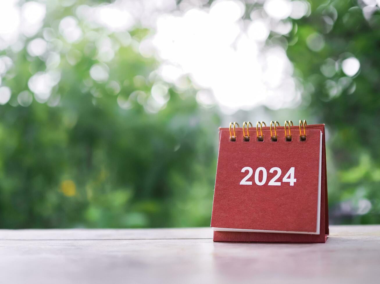 Close up 2024 desk calendar on the table with copy space. Resolution, Goal, Action, Planning, and manage to success business. photo