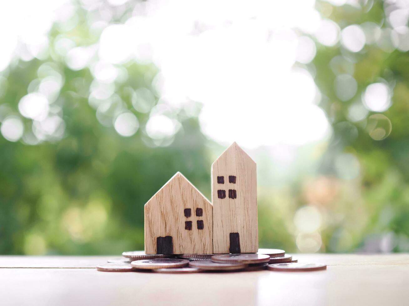 Miniature house on stack of coins. The concept of saving money for house, Property investment, House mortgage, Real estste. photo