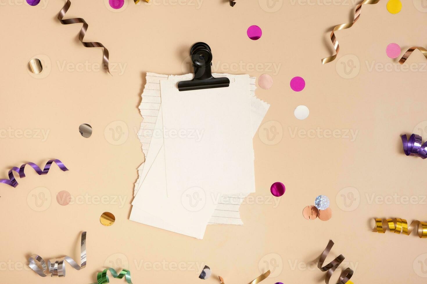 Blank sheet paper. Empty paper sheet with festive confetti and spirals. photo