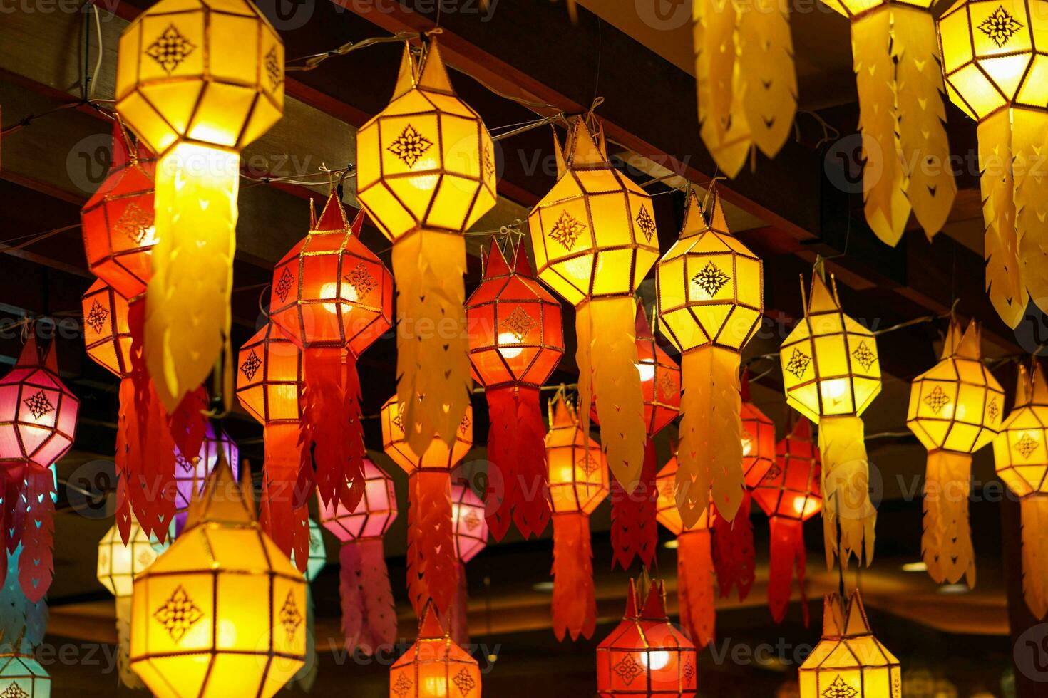 Closeup Colorful perspective view of Thai Lanna style lanterns to hanging on the ceiling and turn on light at night. photo