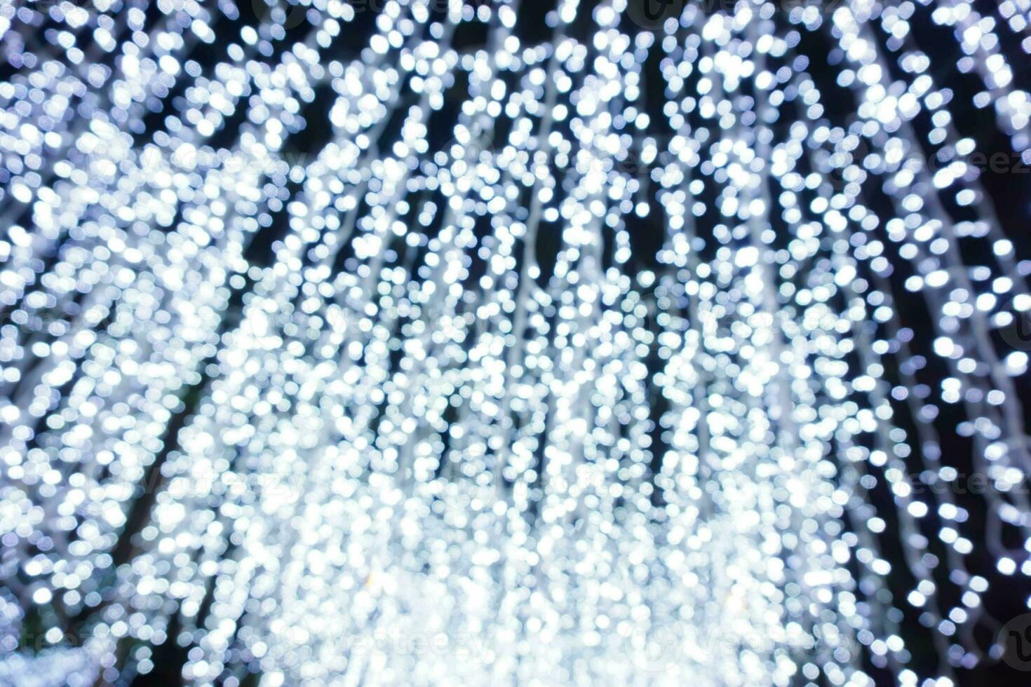 Blurred and bokeh of white curtain led lighting on night time background photo