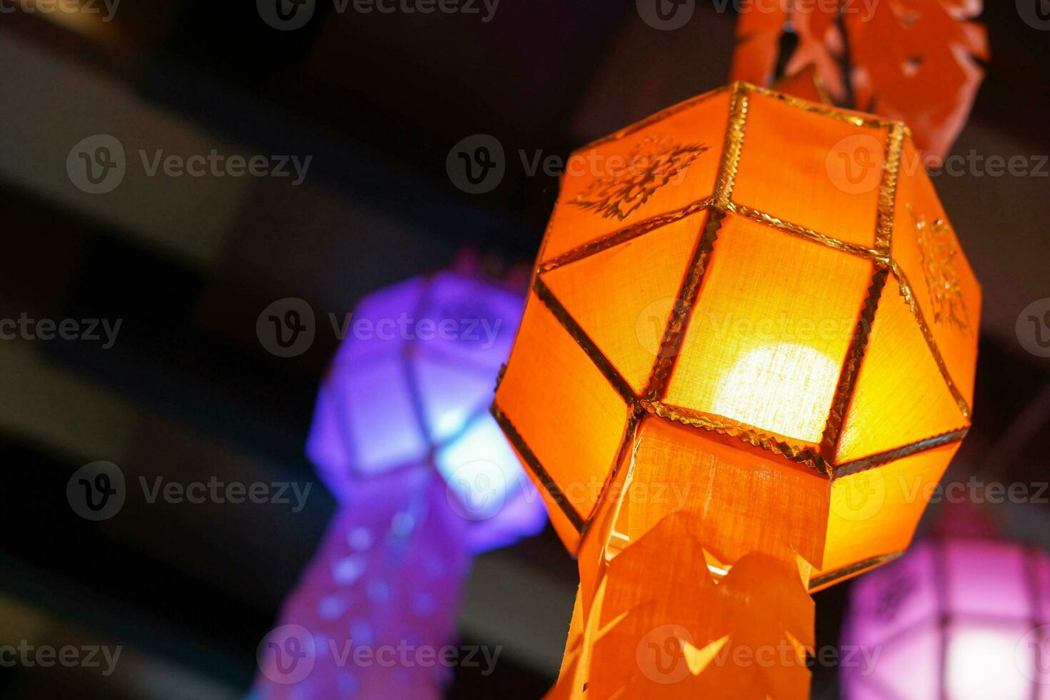 Closeup Colorful Thai Lanna style lanterns to hanging and turn on light at night. photo