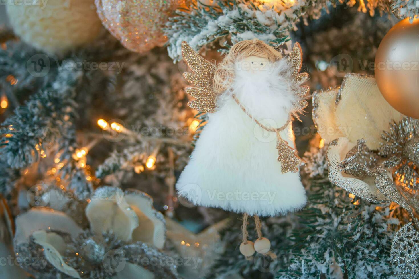 angel Christmas tree toy on branches. Close-Up Of Christmas Decoration Hanging photo