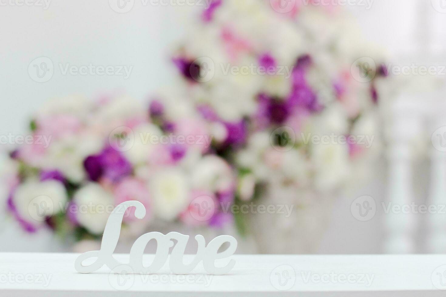 inscription love on a background of flowers photo